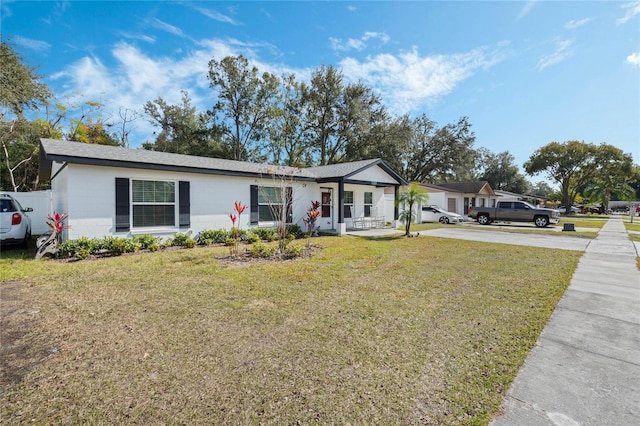 ranch-style home featuring a front yard and covered porch