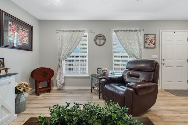 sitting room featuring a textured ceiling and light hardwood / wood-style flooring