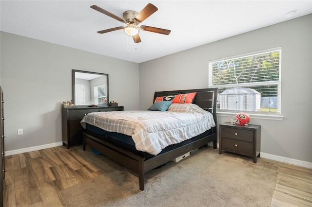 bedroom featuring hardwood / wood-style flooring and ceiling fan