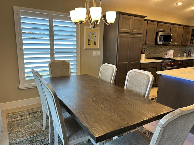 tiled dining area with an inviting chandelier