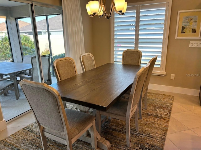 dining room featuring light tile patterned floors and a chandelier