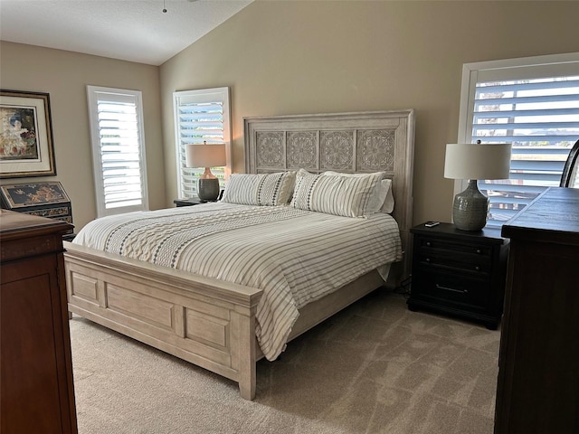 bedroom with light carpet and vaulted ceiling