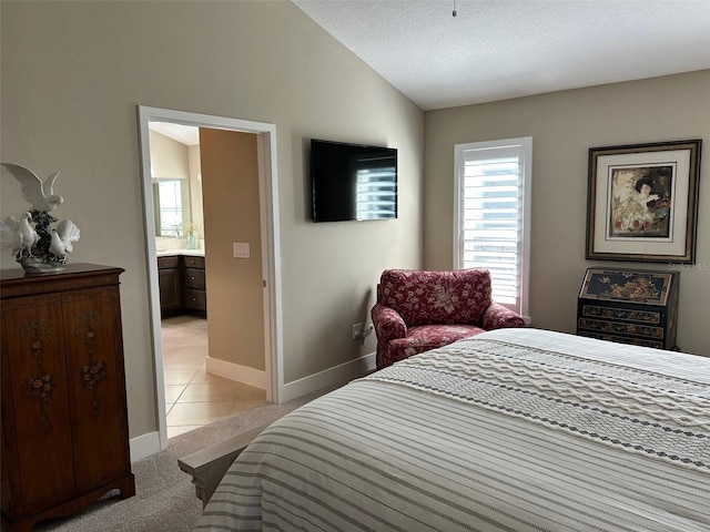 carpeted bedroom featuring vaulted ceiling and a textured ceiling