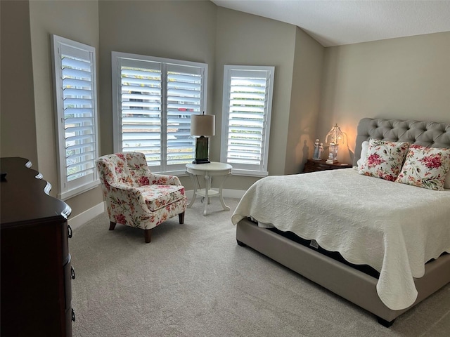 bedroom featuring carpet flooring and vaulted ceiling