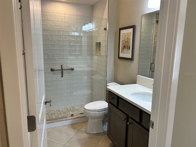 bathroom with vanity, an enclosed shower, tile patterned floors, and toilet