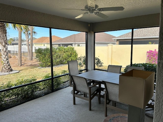 sunroom featuring ceiling fan