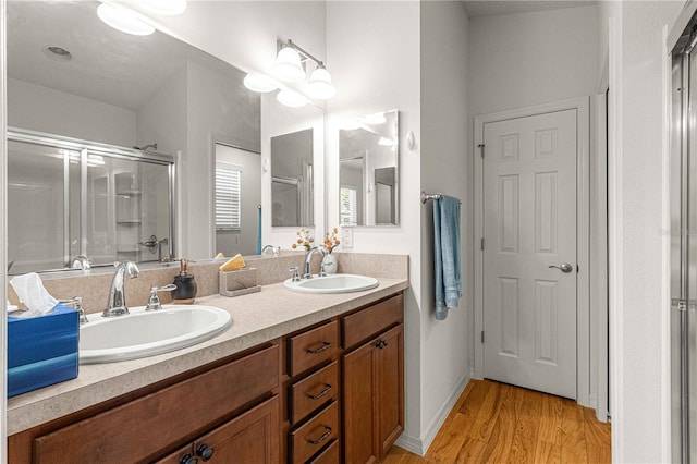 bathroom featuring walk in shower, wood-type flooring, and vanity