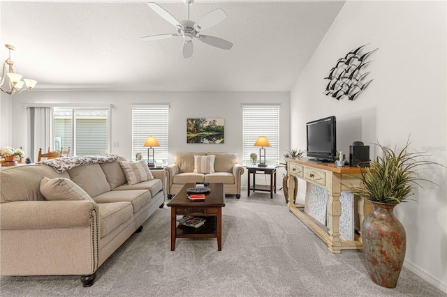 living room with vaulted ceiling, light colored carpet, ceiling fan with notable chandelier, and a textured ceiling