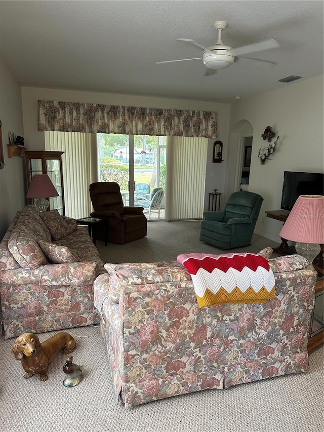 living room featuring ceiling fan and carpet flooring