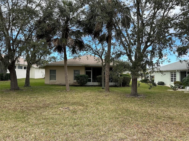 back of property featuring a yard