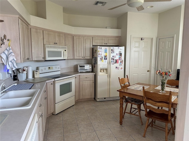 kitchen featuring light tile patterned flooring, light brown cabinetry, sink, white appliances, and ceiling fan