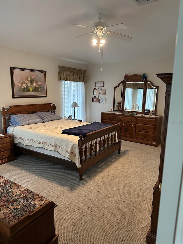 bedroom featuring ceiling fan and light carpet