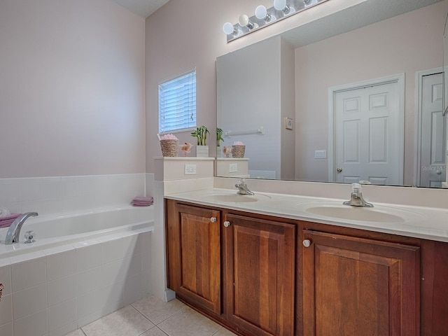 full bathroom with double vanity, tile patterned flooring, a sink, and a bath