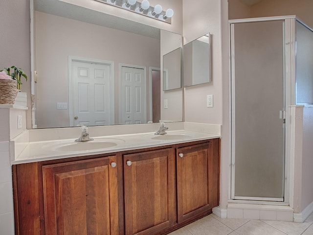 full bath with double vanity, a closet, tile patterned flooring, and a sink