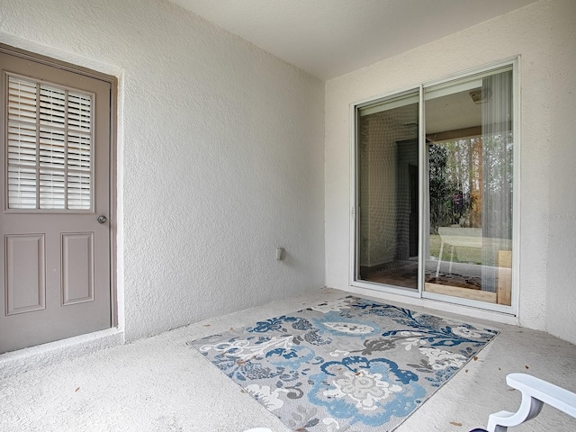 view of exterior entry with stucco siding