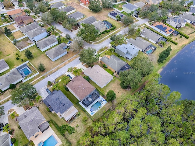 drone / aerial view featuring a water view and a residential view