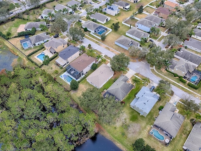 drone / aerial view with a residential view and a water view