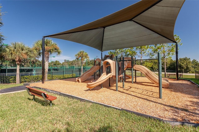 community playground with a water view and fence