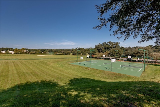 view of community featuring community basketball court and a lawn