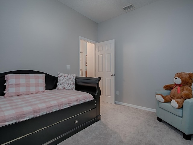 bedroom with light carpet, visible vents, and baseboards