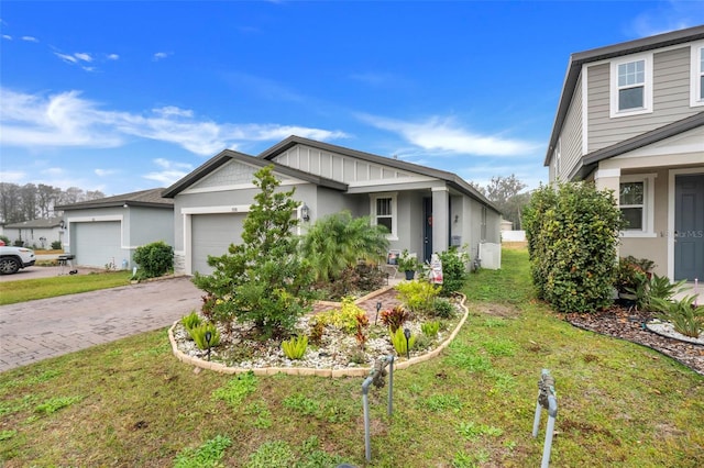 view of front of property featuring a garage and a front yard