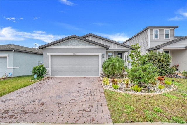 view of front of house with a garage and a front yard