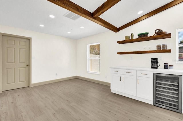 bar featuring wine cooler, light wood-style flooring, recessed lighting, baseboards, and beam ceiling