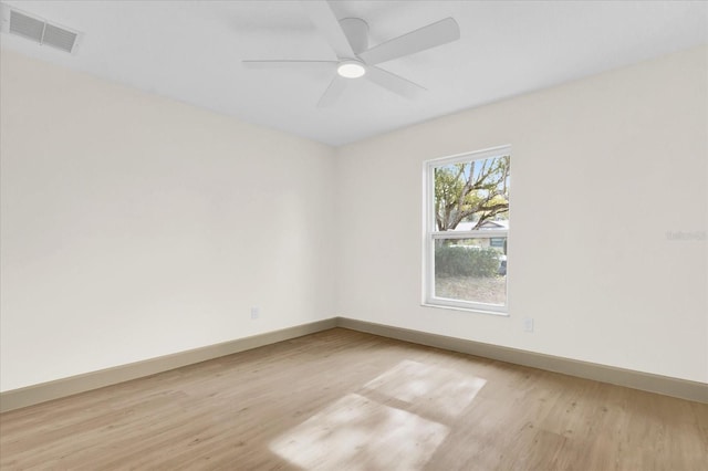 empty room with light wood-type flooring, baseboards, visible vents, and ceiling fan