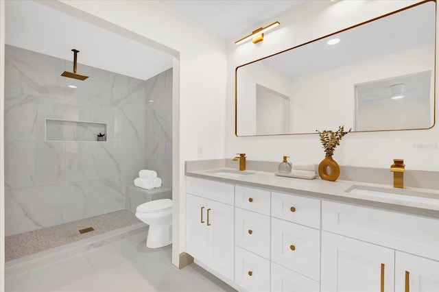 bathroom featuring double vanity, a sink, and a marble finish shower