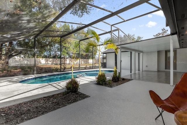 view of swimming pool with a fenced in pool, a patio area, glass enclosure, and fence