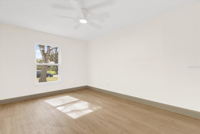 unfurnished room with ceiling fan, light wood-type flooring, and baseboards