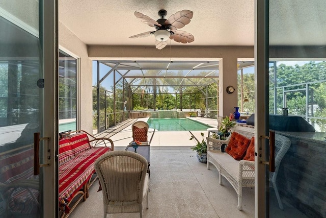 sunroom featuring ceiling fan