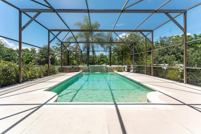 pool with a lanai, a jacuzzi, and a patio