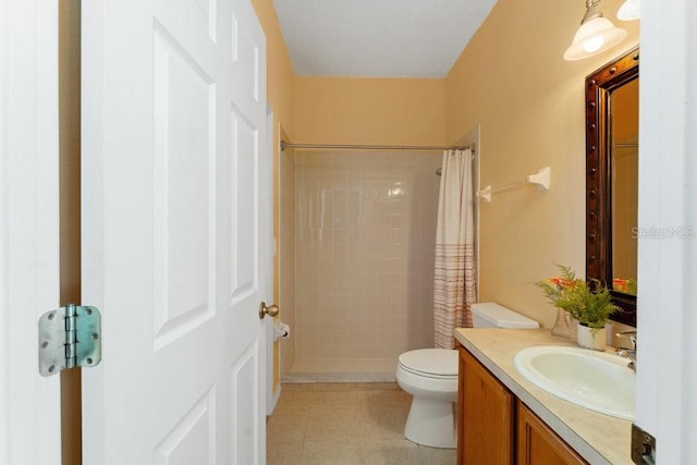 bathroom with a shower stall, toilet, and vanity