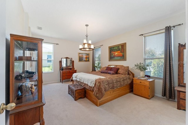 bedroom featuring light colored carpet, multiple windows, a notable chandelier, and visible vents