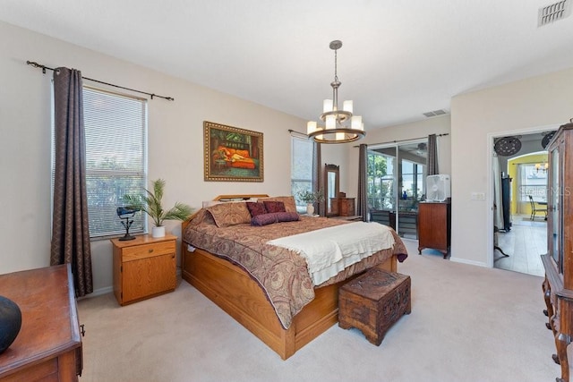 bedroom featuring light carpet, an inviting chandelier, access to outside, and visible vents