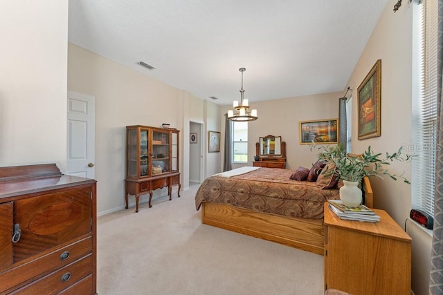 bedroom with visible vents, light carpet, baseboards, and an inviting chandelier