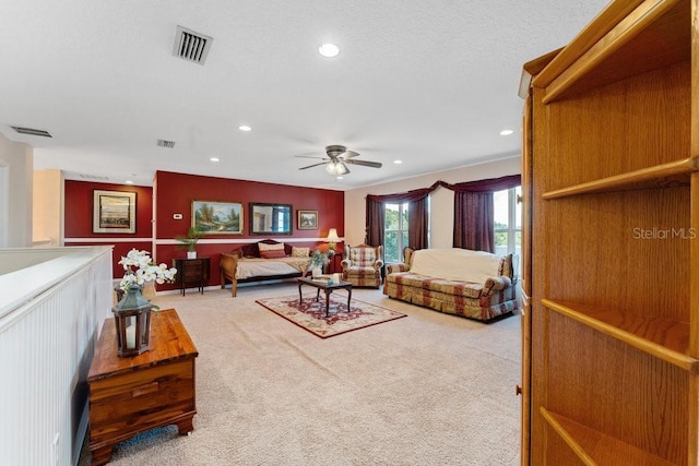 living room featuring light carpet, visible vents, and recessed lighting