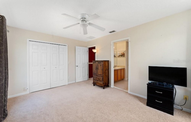 bedroom featuring light colored carpet, a closet, visible vents, and baseboards