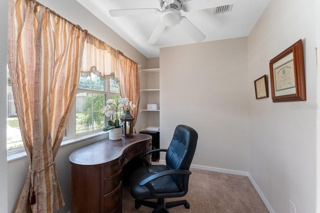 carpeted office with a ceiling fan, visible vents, and baseboards