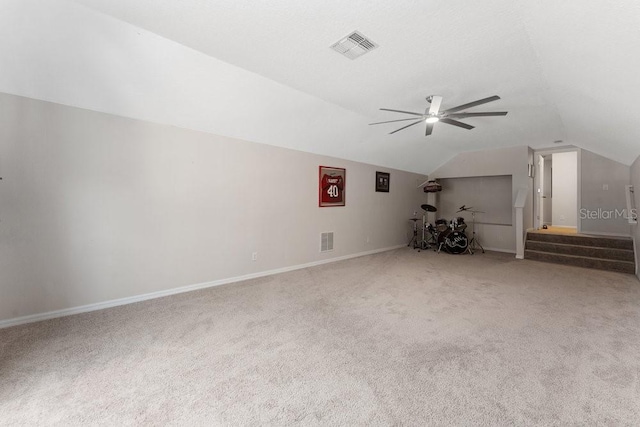 additional living space with vaulted ceiling, carpet floors, ceiling fan, and visible vents