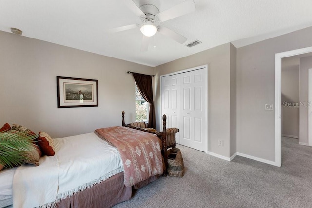 carpeted bedroom with ceiling fan, a closet, visible vents, and baseboards