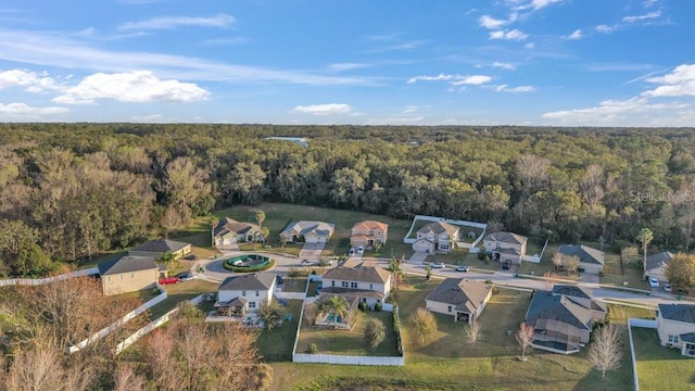 bird's eye view featuring a forest view and a residential view