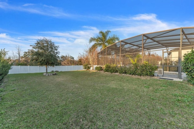 view of yard with a lanai and a fenced backyard