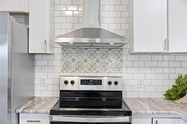 kitchen featuring extractor fan, white cabinets, stainless steel appliances, light stone countertops, and backsplash