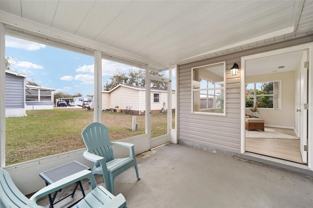 unfurnished sunroom with wooden ceiling