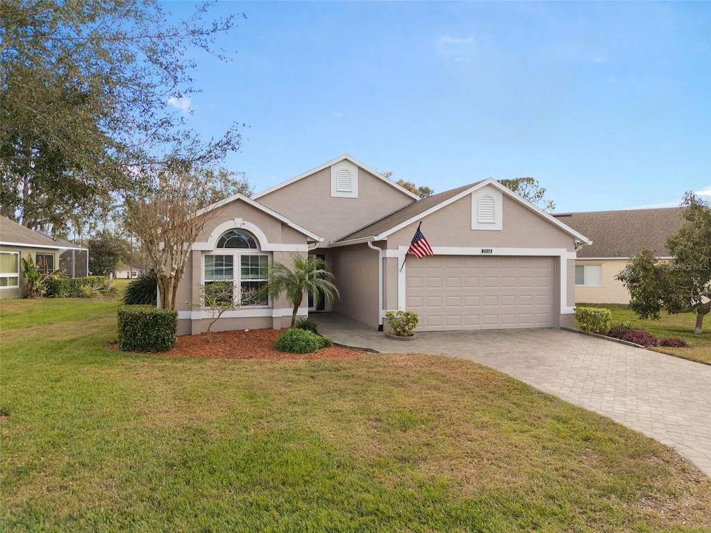 view of front of house featuring a garage and a front lawn