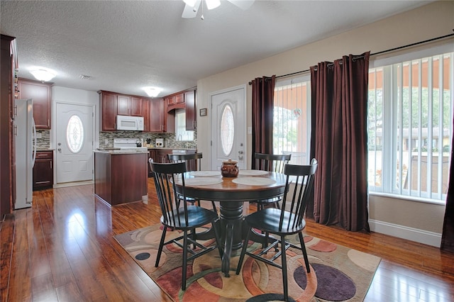 dining area featuring ceiling fan, dark hardwood / wood-style floors, and a textured ceiling