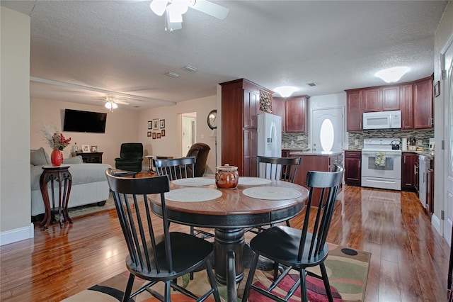 dining room with dark hardwood / wood-style floors, a textured ceiling, and ceiling fan