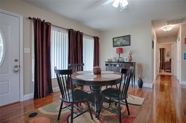 dining room featuring hardwood / wood-style floors and a textured ceiling